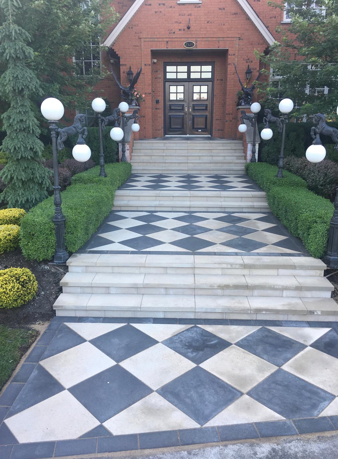 Elegant front entrance with checkerboard pavers